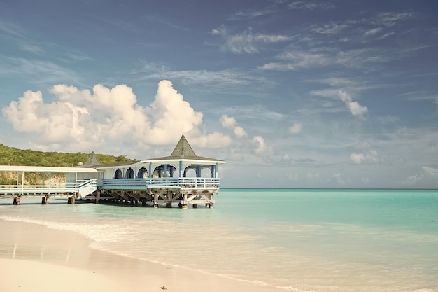 Come and stay Sea turquoise calm and bungalow terrace on water Vacation sea sand beach cozy tropical house bungalow stjohns antigua Idyllic sunny day at seaside blue sky Paradise sea resort