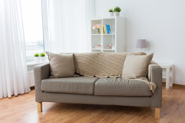 Photo comfort, furniture and interior concept - sofa with cushions at cozy home living room