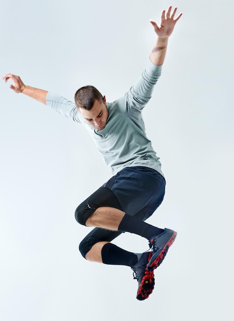 The comfort zone is a made up place Shot of a young man jumping in mid air against a gray background