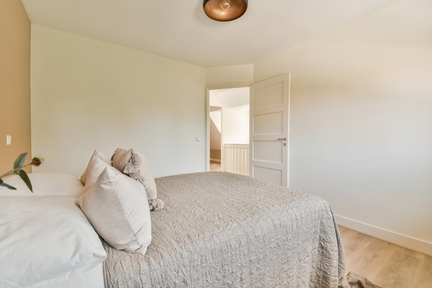 Comfortable bed in light bedroom