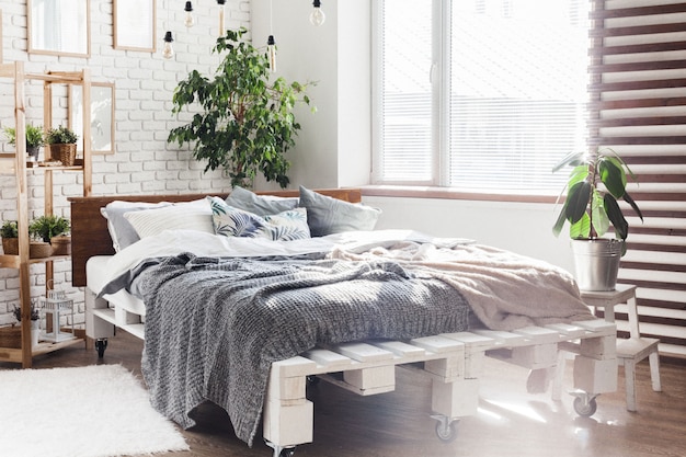 Comfortable bed with pillows in room