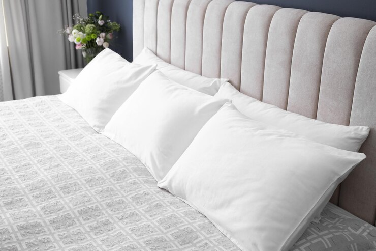 Photo comfortable bed with soft pillows indoors closeup