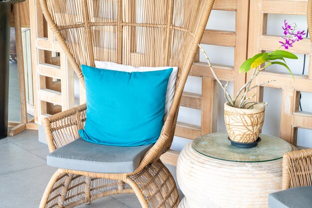 Comfortable chair with pillow on patio