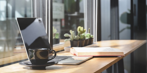 Comfortable co-working space with laptop computer and document with decorations 