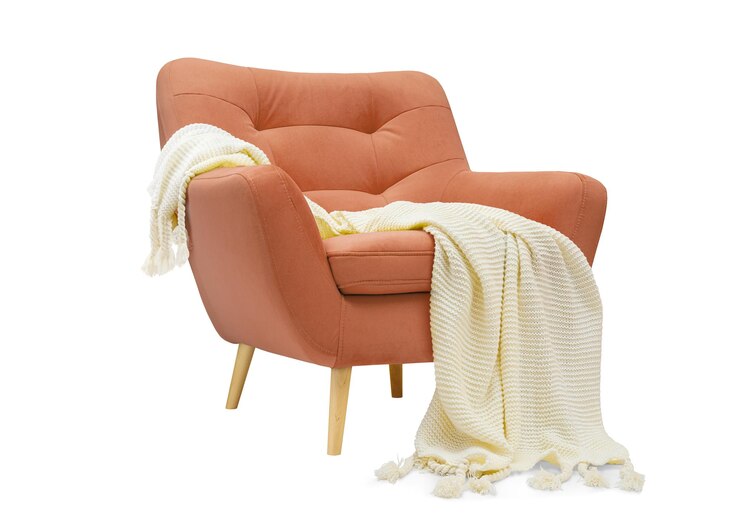 Photo comfortable coral pink armchair with white plaid isolated on white background