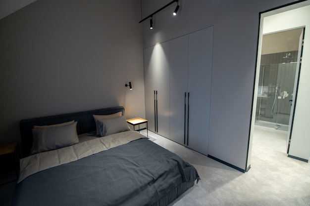 Comfortable double bed positioned against the wall at the
built-in wardrobe with the downlight hanging led lamps