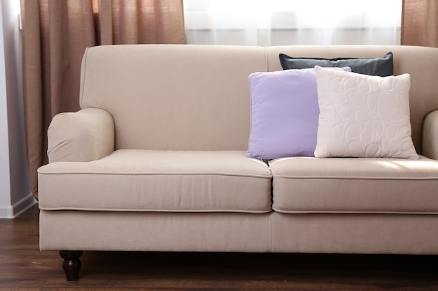 Photo comfortable sofa with pillows in the room close up