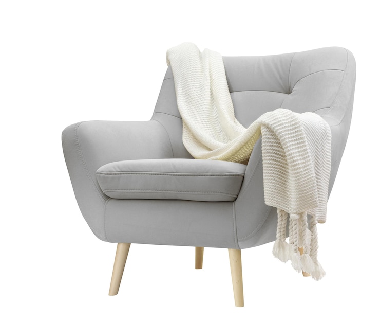 Photo comfortable velour armchair with knitted plaid on white background