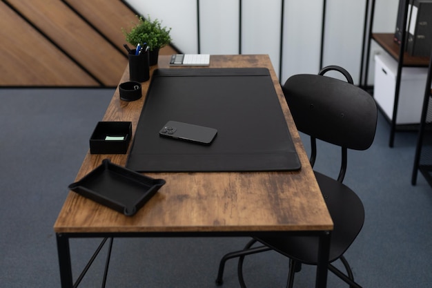 Comfortable workplace at the office table in a stylish office with leather stationery accessories