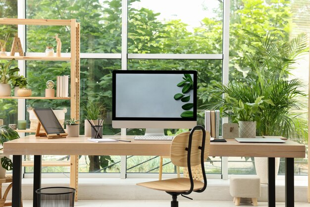 Comfortable workplace with computer in light room Interior design