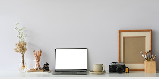 Comfortable workspace that surrounded by white screen computer laptop,