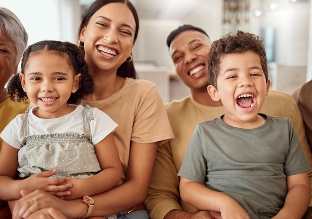 Comic portrait and children with parents on the sofa in the living room of their house together Funny happy and playful kids with mother and father for love care and comedy in their family home