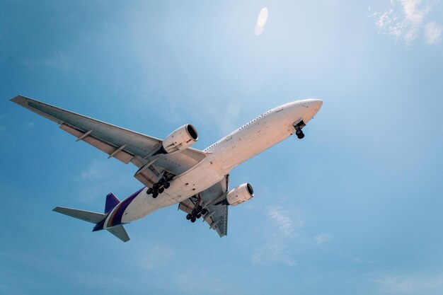 Commercial airplane is flying above clouds. Fast travel around the world. View from below.