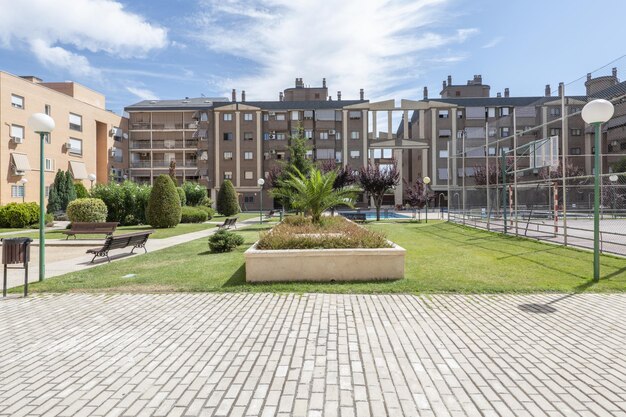 Common areas with a 7aside soccer field basketball hoops palm trees hedges and shrubs in gardens and children's play areas in a residential development