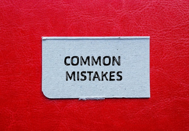Common mistakes words written on torn paper piece with red background