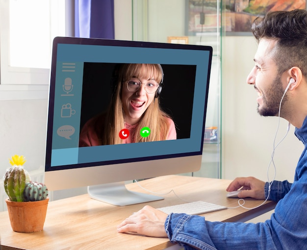 Communicate with his girlfriend on the computer in video chat.\
talking to a girl through the webcam.