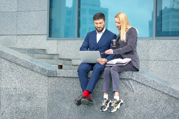 Photo communication of business partners in an urban setting successful businessmen man and woman