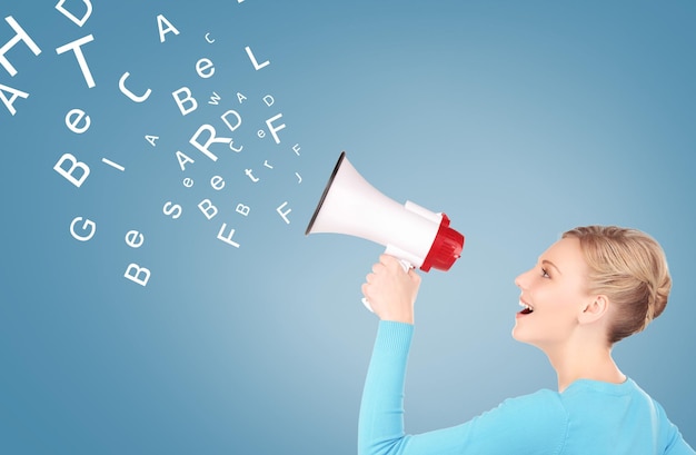 communication concept - woman with megaphone over blue background