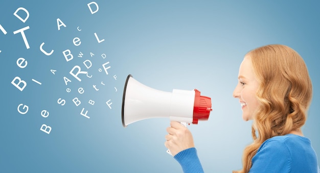 communication concept - woman with megaphone over blue background