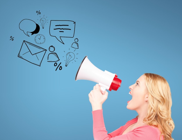 communication concept - woman with megaphone over blue background