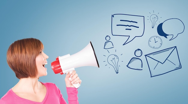 Photo communication concept - woman with megaphone over blue background