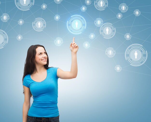 communication and future technology concept - attractive teenager in casual clothes pointing her at social network