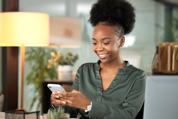 Communication is an important step towards success. Cropped shot of an attractive young businessman sending a text while working at her desk in the office.