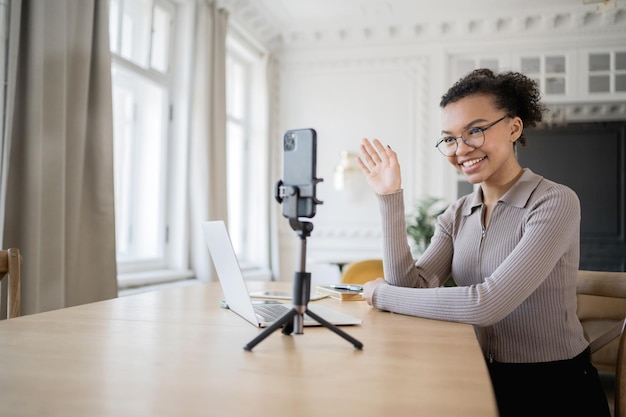 communication online video communication with colleagues blogger woman work modern office uses phone