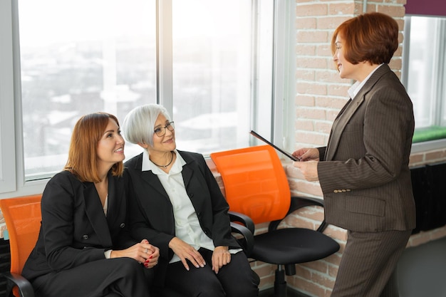 communication of three successful business women in the office