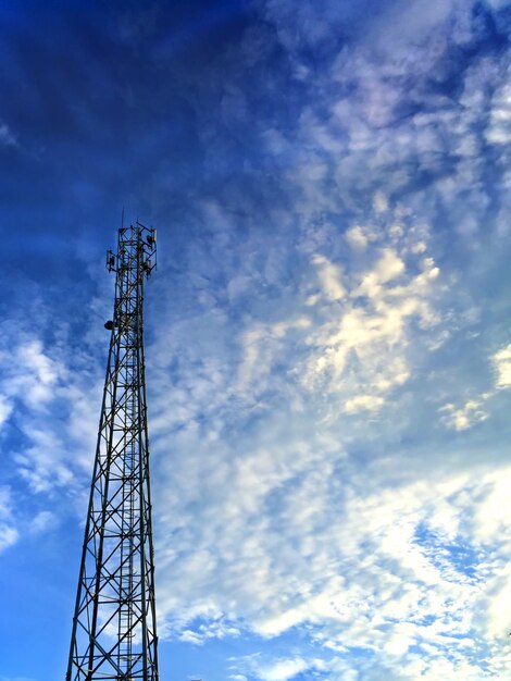 Communication Tower over Blue Cloudy Sky