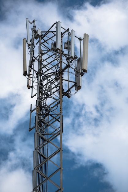 Communication Tower with antennas such a Mobile phone tower, Cellphone Tower, Phone Pole etc on the sky with clouds background. 