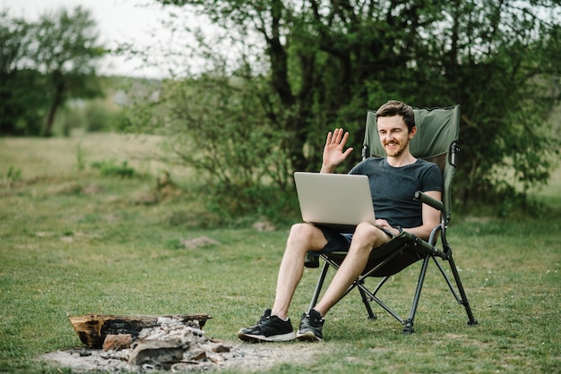 Communication with relatives, family online on laptop on nature. Man briefing the team at the conference or remote work consultation,  worker speak talk on video call with colleagues.