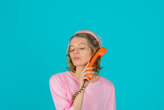 Communication woman with retro phone lovely woman in pink dress with telephone handset happy woman