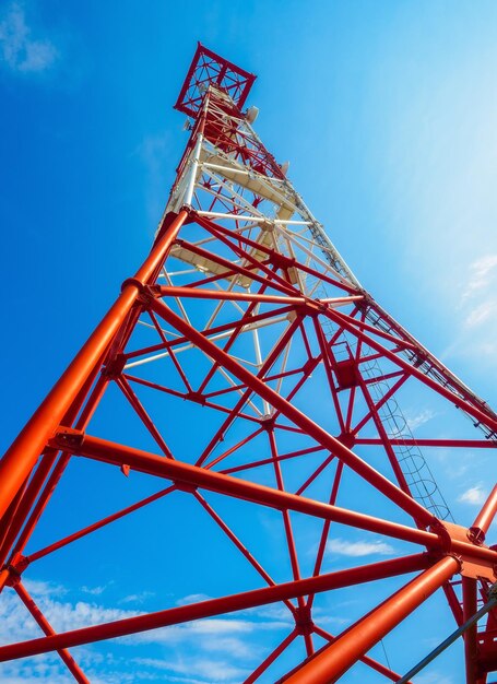 Communications tower against blue sky View from bottom to top Epic tall communications mast Background