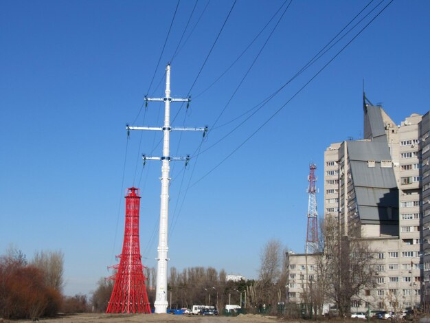 Communications tower and buildings against clear blue sky