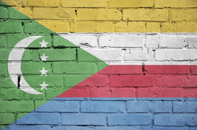 Comoros flag is painted onto an old brick wall