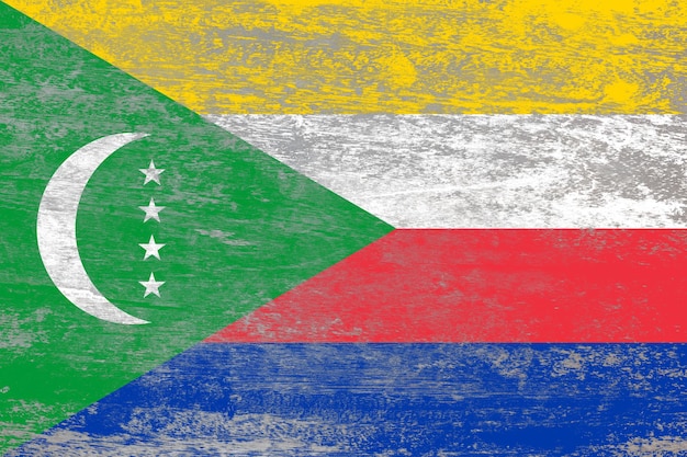 Comoros flag painted on a damaged old wooden background