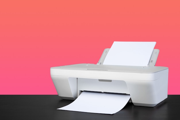 Photo compact home laser printer against pink background