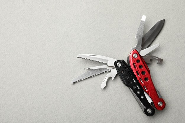 Compact portable multitool on light grey background top view Space for text