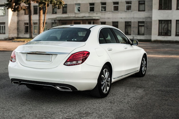 Compact white executive car, with beautiful wheels, large chrome grille.