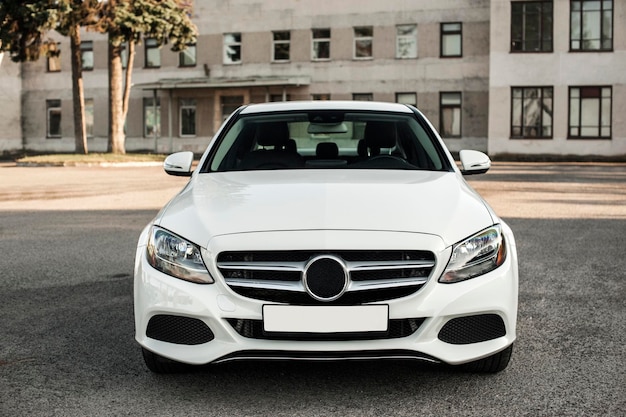 Compact white executive car, with beautiful wheels, large chrome grille.