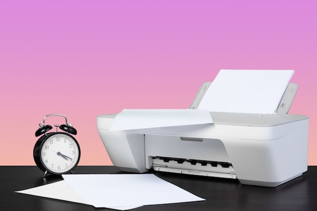 Compacte laserprinter voor thuis tegen een roze achtergrond