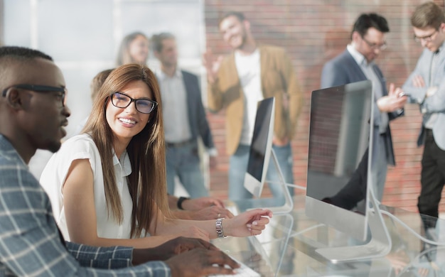 Company employees discussing work issues at the Desk in the office