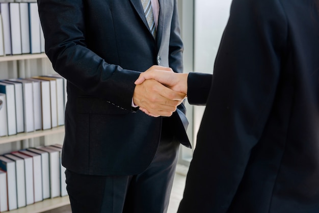 Company employees shake hands