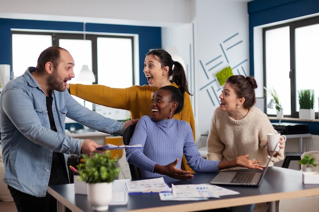 Company executive and diverse team cheerful because of company statistics