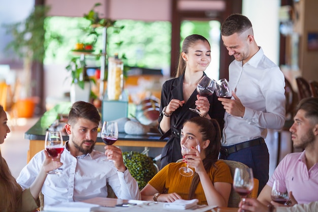 Company of friends celebrates meeting in a restaurant.