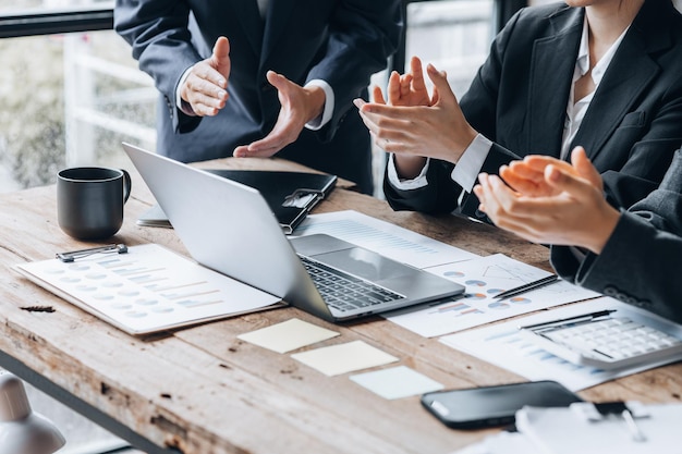 Company meeting room has businessmen and finance managers meeting together on finance topics they are applauding after the meeting is over Concept company financial management