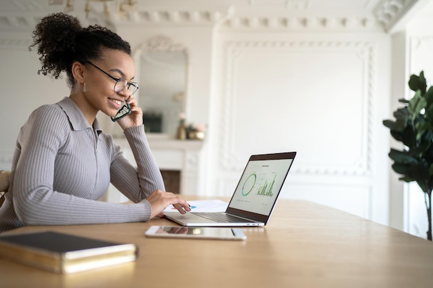 Company report A millennial freelancer works in an office uses a laptop to surf the Internet