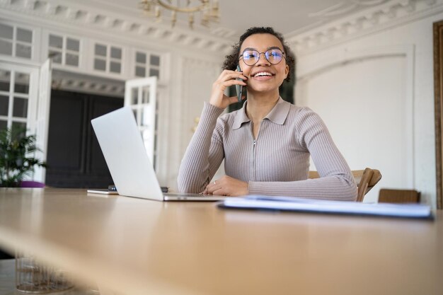 Photo company report a millennial freelancer works in an office uses a laptop to surf the internet