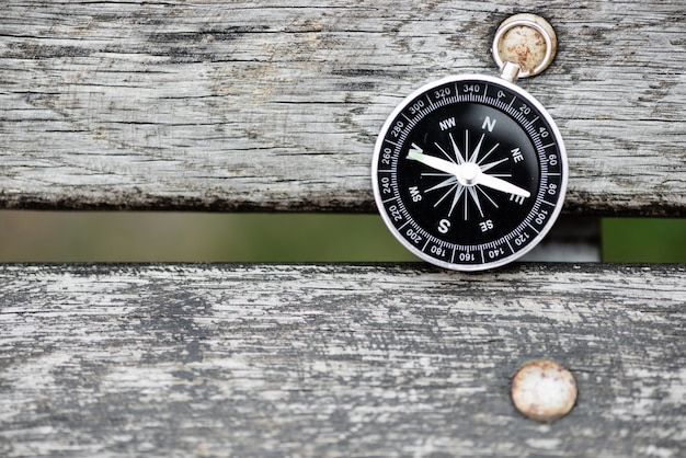 Compass on a beautiful wooden surface. Top view